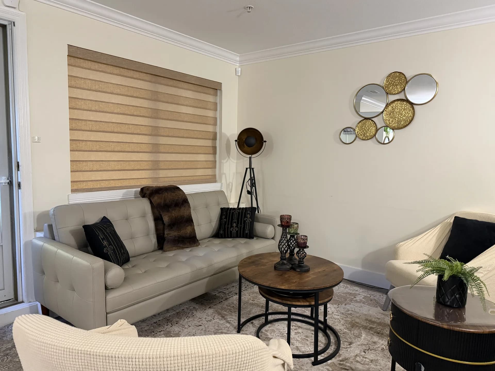 Layered zebra blind above a sofa in a bright living room