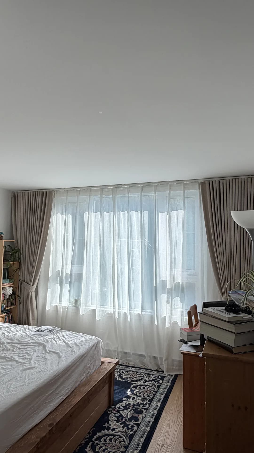 Sheer curtains with grey drapes in a bedroom